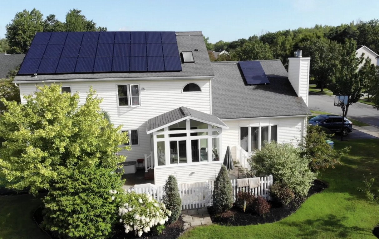 Aerial view of white-framed sunroom attached to a home with solar panels in Thousand Oaks, CA