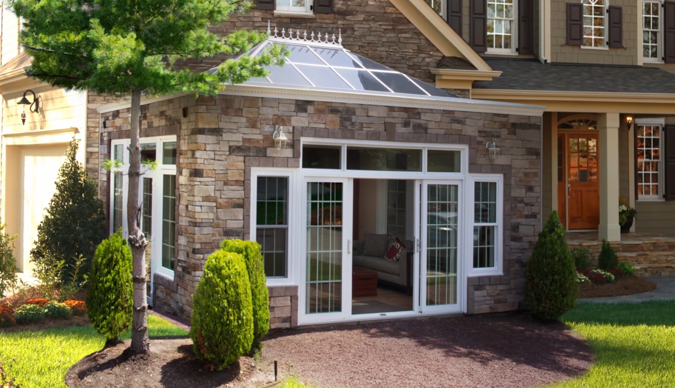 White traditional-style sunroom with glass panels attached to a brick home in Thousand Oaks, CA